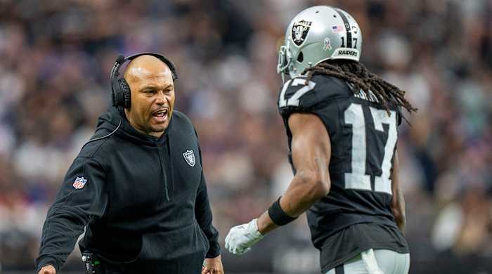 Raiders interim head coach Antonio Pierce (left) high-fives wide receiver Davante Adams (17) after a touchdown against the Giants during the first quarter at Allegiant Stadium.